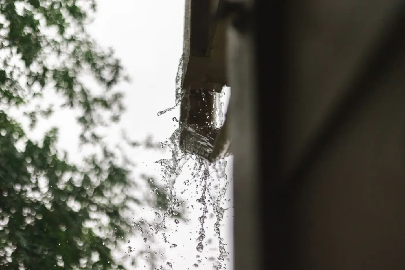 Rainwater moving along a residential roof gutter