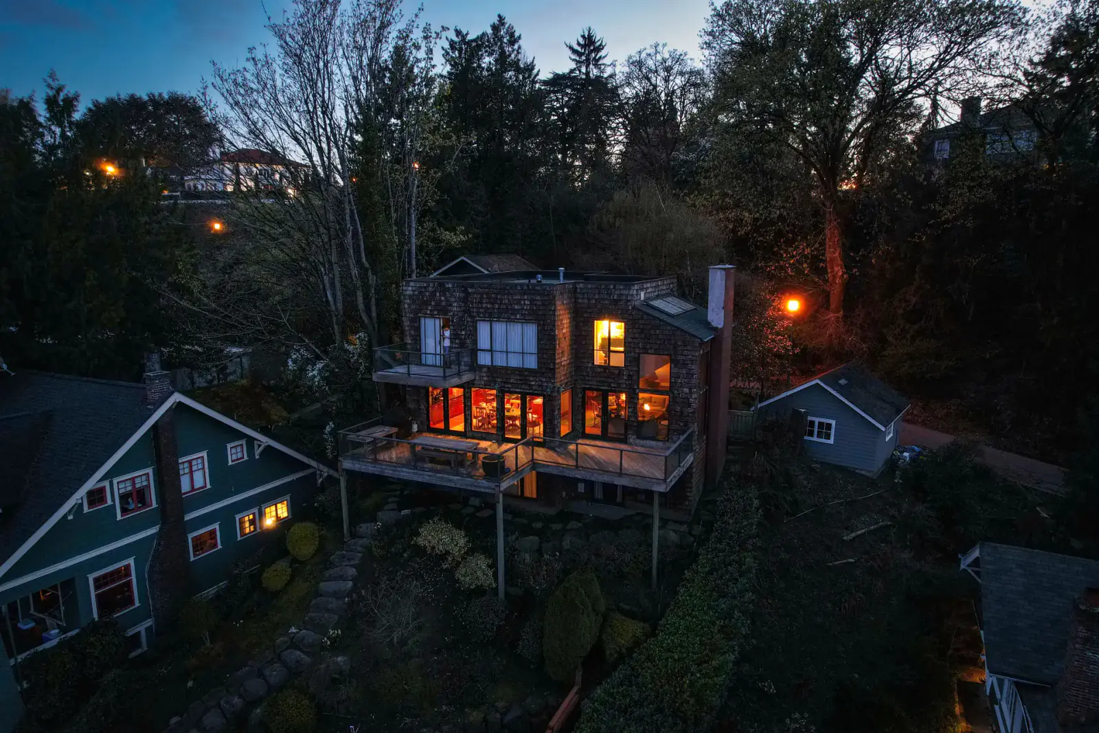 An illuminated home in a wooded Seattle-area setting